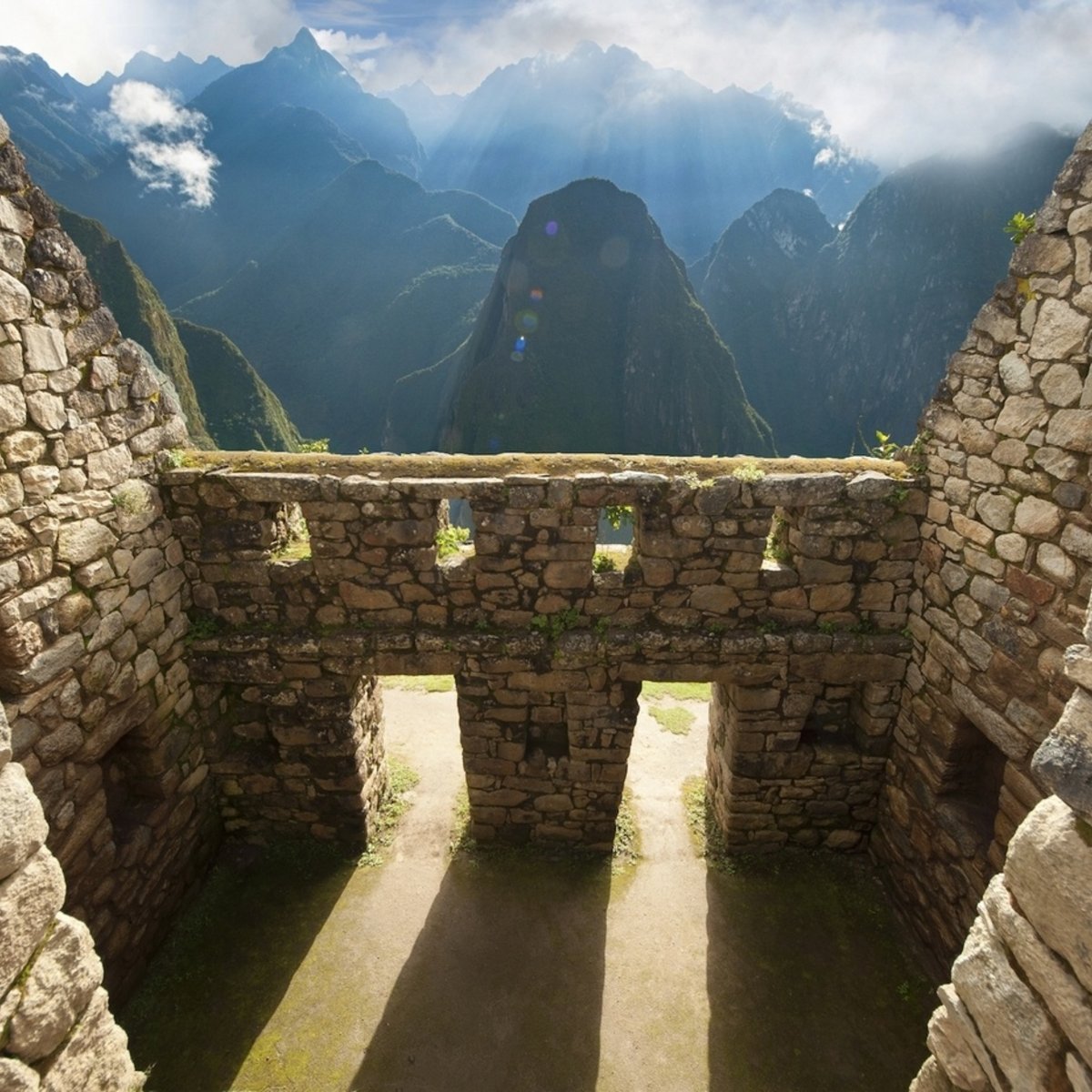 Building at Machu Picchu with clouds in the background