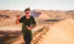 Traveller exploring Sossusvlei Sand Dunes in Namib Desert, Namibia, Africa