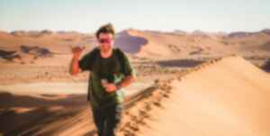 Traveller exploring Sossusvlei Sand Dunes in Namib Desert, Namibia, Africa
