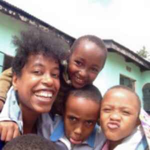 Naila and kids from an orphanage smiling and pulling silly faces