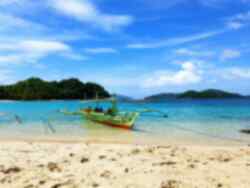 A bangka boat on the shore of a Philippines beach