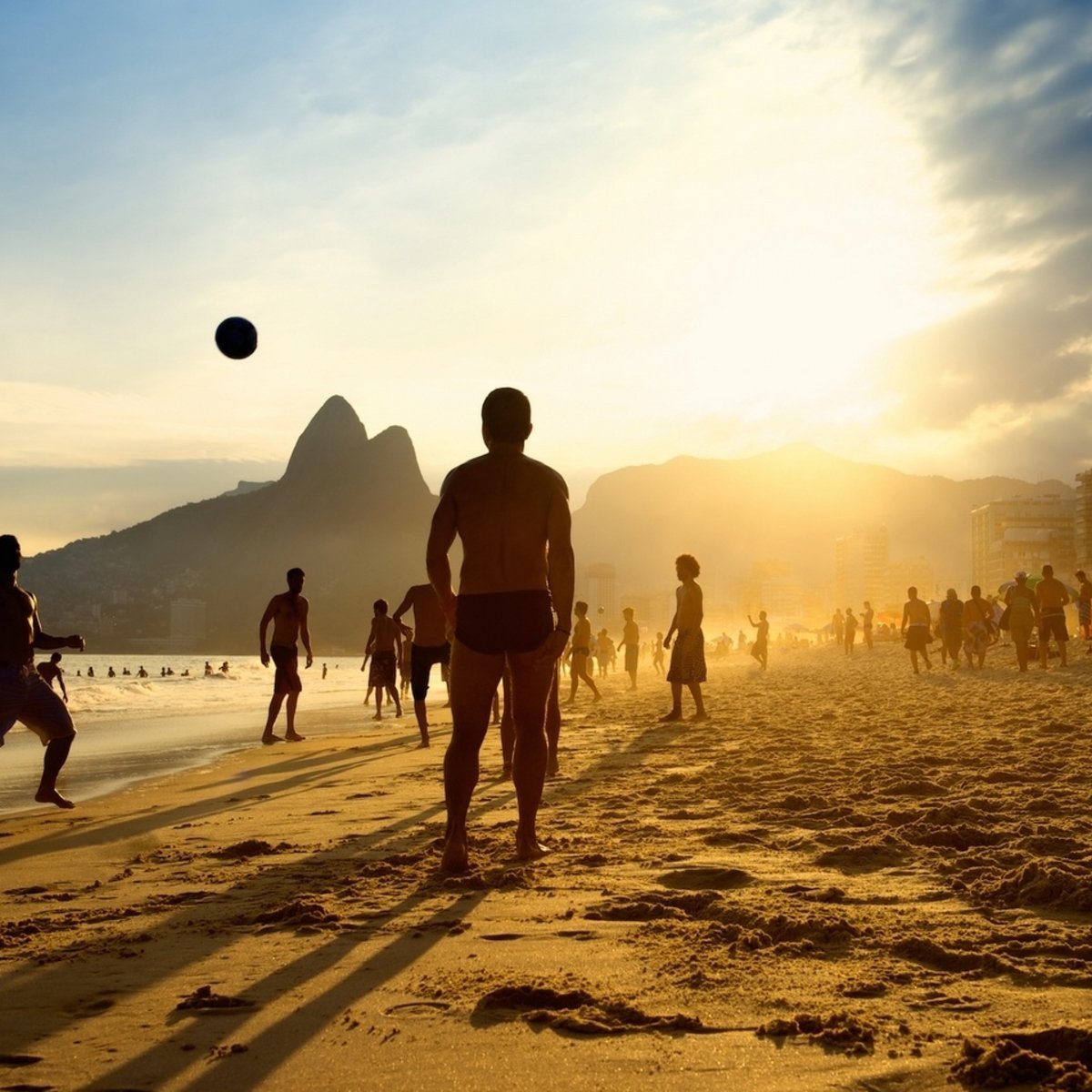 Group playing football on a beach in Rio
