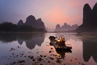 Fisherman in Yangshuo by the mountains