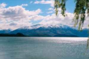 A pristine lake below snow-capped mountain in Wanaka, New Zealand