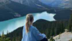 Traveller looking across Peyto Lake in Banff National Park in the Canadian Rockies