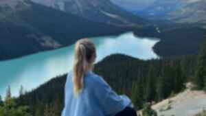 Traveller looking across Peyto Lake in Banff National Park in the Canadian Rockies
