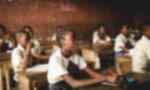 African schoolkids sitting at their desks in a classroom