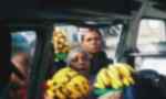 Street vendors trying to sell bananas to people in a vehicle in Tanzania