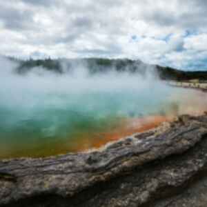 Steam rising from a geothermal lake in Rotorua, New Zealand