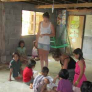 Volunteers in a classroom helping children with schoolwork