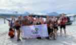 Travellers holding up a Gap 360 Thailand banner