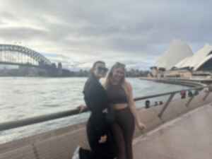 Two people stood in front of Sydney Harbour Bridge and Sydney Opera House, Australia
