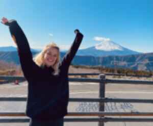 Traveller with hands up in front of Mount Fuji, Japan 