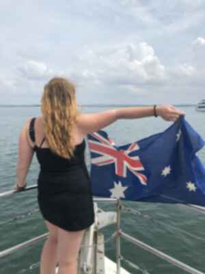 Traveller waving Australian Flag on Sydney Harbour Cruise, Australia