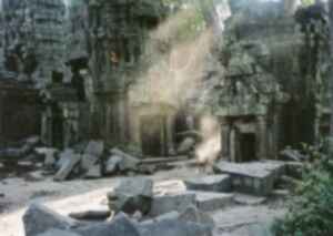 A monk sweeps temple ruins in Cambodia
