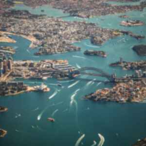 Aerial view of the Sydney Harbour Bridge and surrounding bay and city