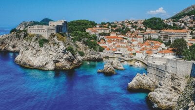 Croatia, Dubrovnik coastline with buildings and blue waters 