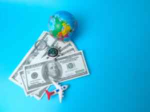 Small globe and money and toy plane