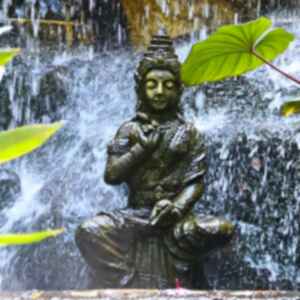 A Buddha statue under falling water at Wat Saket (Golden Mount) in Bangkok