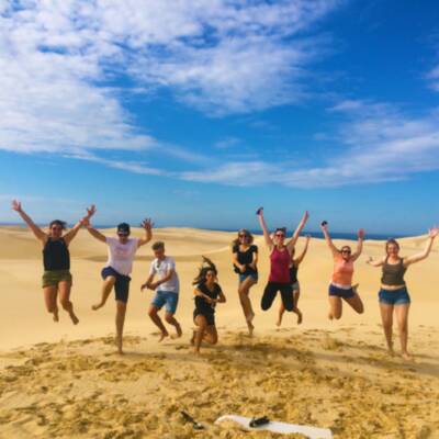 Group jumping on sand dunes
