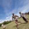 Two Tanzanian schoolchildren playing football