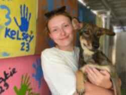 Volunteer holding dog on Thai Animal Welfare trip